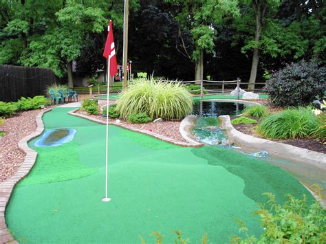 Minuture gold - Miniature golf. Miniature golf (also known as minigolf, putt-putt, crazy golf, and by several other names) is an offshoot of the sport of golf focusing solely on the putting aspect of its parent game. The aim of the game is to score the lowest number of points. It is played on courses consisting of a series of holes (usually a multiple of 9 ... 